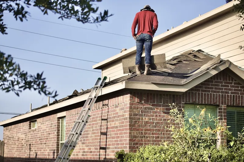 Professional roofer working on a residential roof in North Salem